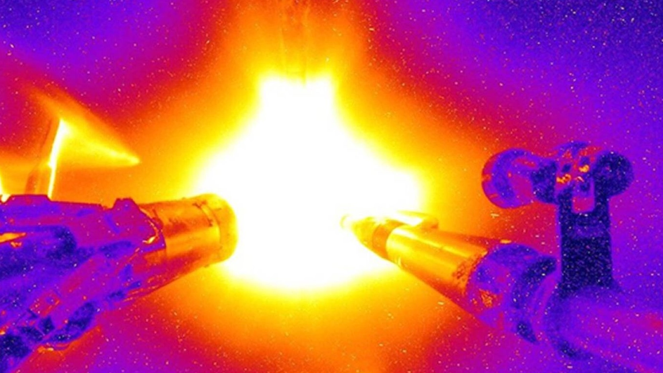 Aerial view of a nuclear power plant with glowing interior, symbolizing nuclear energy production.